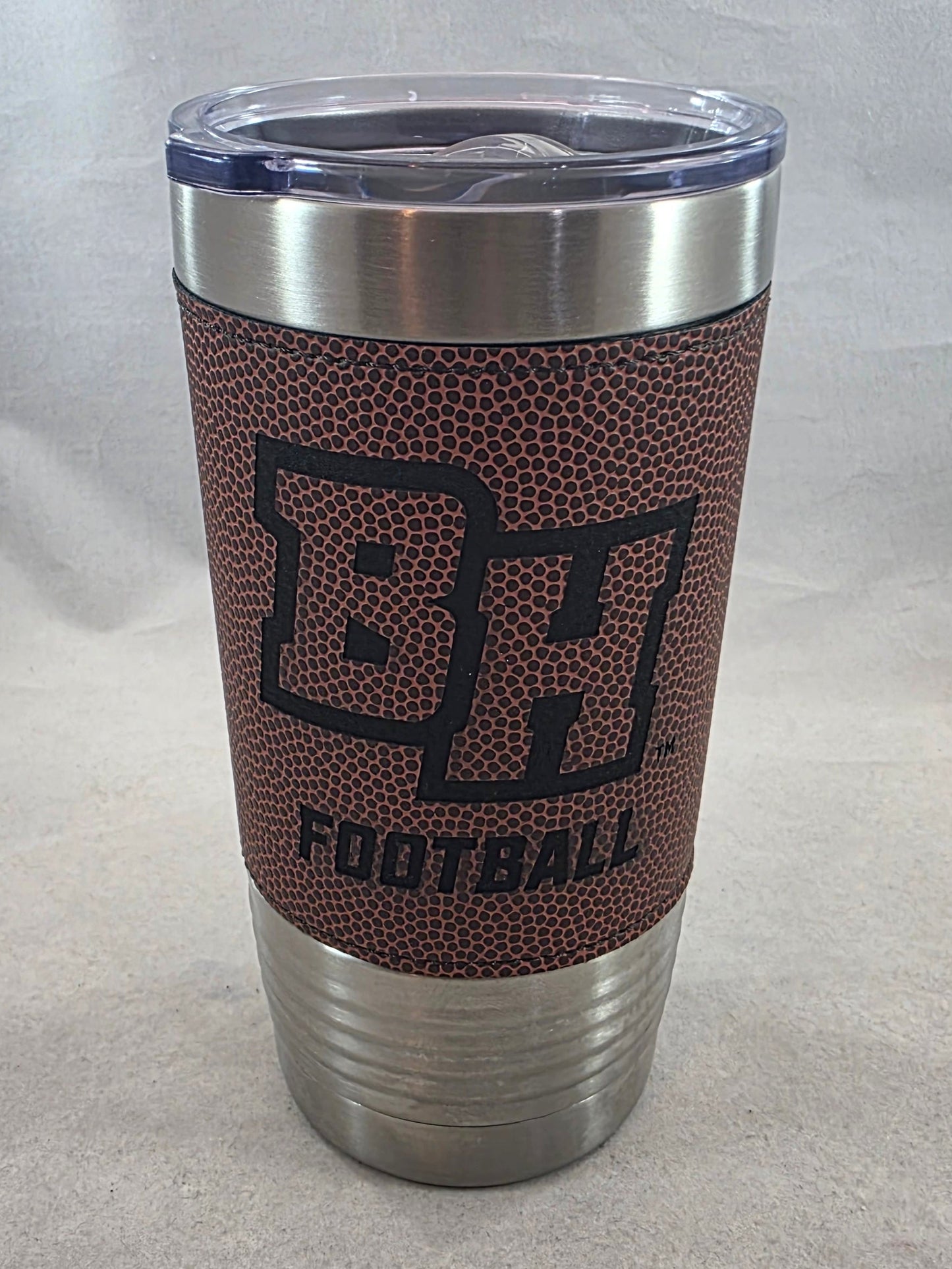 Tumbler with football-themed design on a light gray background